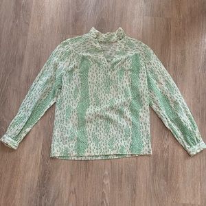 Green and white patterned blouse